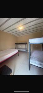 a room with two bunk beds and a ceiling at Sítio vovó Joana 2 in Esmeraldas