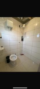 a bathroom with a white toilet in a stall at Sítio vovó Joana 2 in Esmeraldas