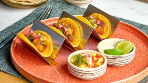 a plate of food with tacos on a table at InterContinental Bangkok by IHG in Bangkok