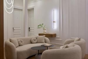 a living room with a couch and two chairs at Athens Icon Collection in Athens