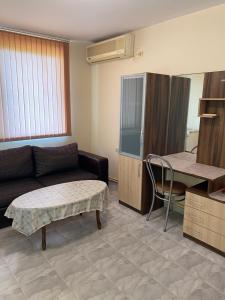 a living room with a couch and a table at Стаи за гости Денкови in Burgas City