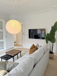 a living room with a couch and a table at Cozy pearl downtown Viborg in Viborg
