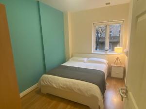 a small bedroom with a bed and a window at Super Central Location Private Room 1 in Dublin +25 photos