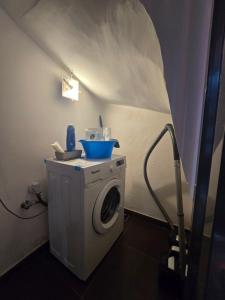 a washing machine with a blue bowl on top of it at Villa Teresa in Leuca