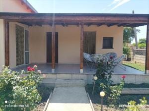 a porch of a house with a chair on it at Winnica u Mirki in Gurkovo +5 photos