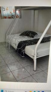 a bedroom with a bunk bed with a staircase at Embruns 2 in Le Moule +15 photos