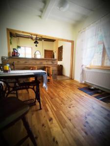 a living room with a wooden floor and a table at STĀRĶA APARTAMENTI in Kuldīga