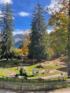 a park with a bench and trees and a fence at Alpe des chaux 61 03 in Gryon +11 photos