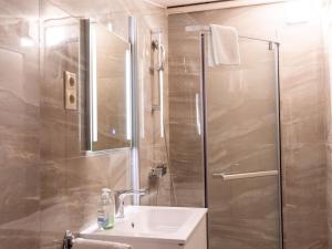 a bathroom with a shower and a sink and a mirror at Apartment Seethurn by Interhome in Strobl