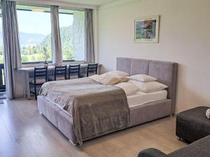 a bedroom with a bed and a table with chairs at Apartment Wohnung 306 Berglick by Interhome in Strobl