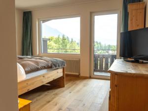 a bedroom with a bed and a large window at Apartment Penthouse Deluxe Galerie 2 stöckig by Interhome in Strobl +64 photos