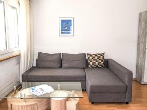 a living room with a couch and a glass table at Apartment Rubin by Interhome in Zermatt