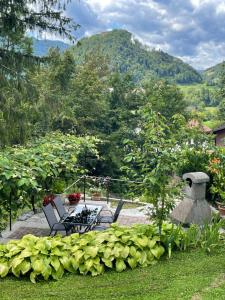 a patio with chairs and a table and a mountain at Apartma Savan in Tolmin