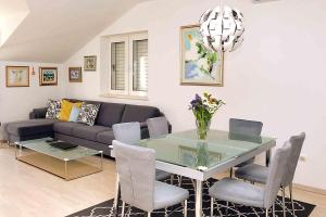 a living room with a couch and a glass table at Apartments Blue Horizon in Mlini