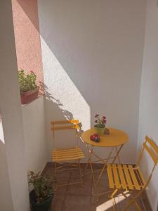 a table and two chairs and a table and chairs at Apartmani Janićijević 2 in Kragujevac +35 photos