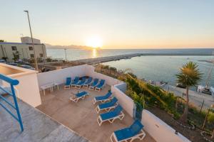 a balcony with chairs and a view of the ocean at Baia Marina Oasi in Balestrate