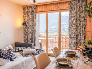 a dining room with a table and a large window at Studio Beau Soleil G11 by Interhome in Veysonnaz +10 photos