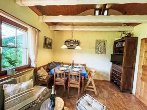 a living room with a table and a couch at Holiday Home Black Forest Hideaway by Interhome in Falkau