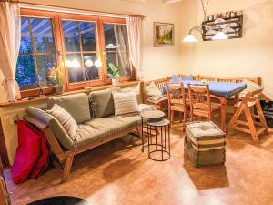 a living room with a couch and a table at Holiday Home Black Forest Hideaway by Interhome in Falkau +35 photos