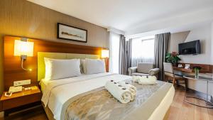 Postel nebo postele na pokoji v ubytování Kent Hotel
