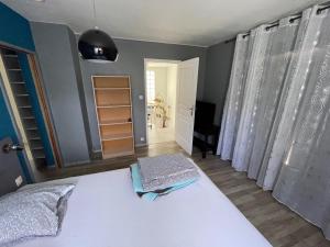 a bedroom with a white bed in a room at Maison blanche in Signes