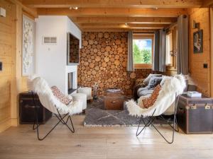 a living room with two chairs and a couch at Chalet Etoile by Interhome in Nendaz