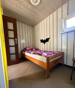 a small bedroom with a bed in a room at Holiday - domek letniskowy 2 in Charzykowy +12 photos