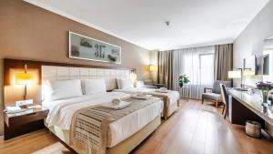 Postel nebo postele na pokoji v ubytování Kent Hotel