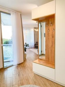 a living room with a large window and a mirror at Villa Hana With Pool in Shetaj +8 photos