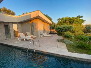 a house with a patio and a swimming pool at Villa Hana With Pool in Shetaj