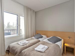 Postel nebo postele na pokoji v ubytování Holiday Home Ruka chalets 3404 by Interhome