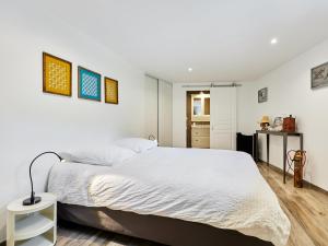 a bedroom with a large bed and a kitchen at Holiday Home Villa Honfleur by Interhome in Gonneville-sur-Honfleur