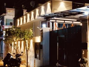 a motorcycle parked in front of a house at night at La Goodwill Garden Luxury villa in Auroville