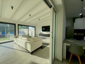 a living room with a white couch and a table at Villa Leonessa in Tremestieri Etneo