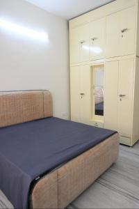 a bedroom with a bed and white cabinets at The Villas Homestay in Jammu