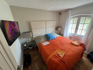 a bedroom with a large bed with a red blanket at Sea view villa - South facing - Grimaud, France in Port Grimaud