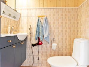a bathroom with a toilet and a sink at Holiday Home Kesäranta by Interhome in Alavus