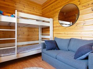 a living room with two bunk beds and a couch at Holiday Home Kesäranta by Interhome in Alavus