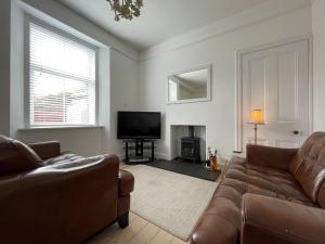 a living room with a couch and a television at Stanford House in Inverness