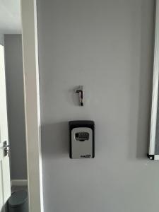 a clock on the side of a white refrigerator at Ravenscourt Rooms by Brabazon Rooms in Bristol +30 photos