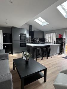 a living room with a kitchen with a table at Ravenscourt Premium by Brabazon Rooms in Bristol