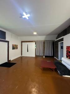an empty living room with a couch and a table at Thessalon Luxury House -Space Share in Thessalon