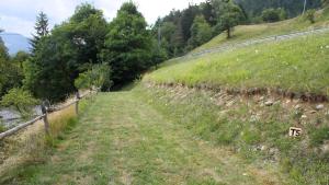 a field of grass with a fence on a hill at Outsidersi Campsite in Savina