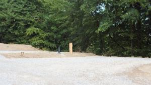 a blue pole in the middle of a field with trees at Outsidersi Campsite in Savina