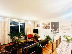 a living room with a couch and a table at Stylish 4BR Artist's Home with Garden- Gdańsk Green District by AVALON ATELIER in Gdańsk