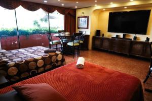 a hotel room with a bed and a table and a television at Casa de Huéspedes en Satélite - Boutique Rosas in Mexico City