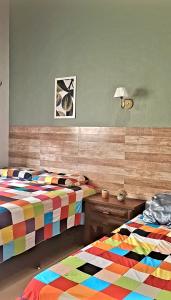 グアラミランガにあるCasa Florença Guaramirangaのカラフルなベッドが2つある寝室 +27枚の写真