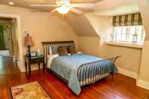 a bedroom with a bed and a ceiling fan at Inns at St Albans in Saint Albans