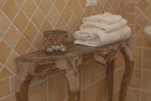 a pile of towels on a table in a bathroom at Borgo di Vezzano in Calenzano