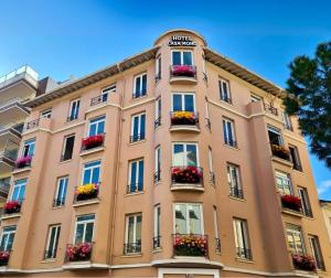 a large building with flower boxes on it at Hôtel CASA MOHO - Juan-Les-Pins in Juan-les-Pins
